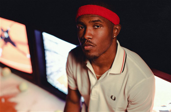 Photo de Frank Ocean avec un bandeau rouge devant des écrans