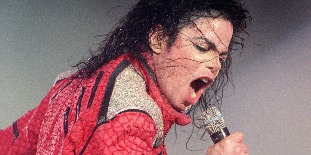 Michael Jackson performs live on stage, 1996. (Photo by Phil Dent/Redferns)