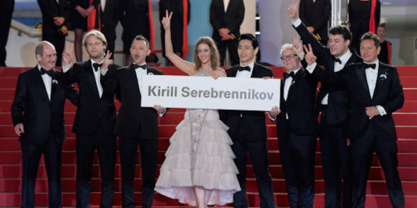 CANNES, FRANCE - MAY 09:  (L-R) President of the festival Pierre Lescure, Producer Ilya Stewart, actors Roman Bilyk, Irina Starshenbaum, actor Teo Yoo, Cannes Film Festival Director Thierry Fremaux and actor Charles-Evrard Tchekhoff with a sign to free Director Kirill Serebrennikov as they attend attends the screening of "Leto" during the 71st annual Cannes Film Festival at Palais des Festivals on May 9, 2018 in Cannes, France.  (Photo by Stephane Cardinale - Corbis/Corbis via Getty Images)