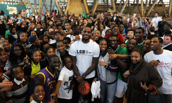 LONDON, ENGLAND - NOVEMBER 13:  NBA basketball player LeBron James poses with fans at a Nike event to celebrate the success of the London School of Basketball Comunity League at the Crystal Palace National Sports Centre on November 13, 2011 in London, England.  The Miami Heat powerhouse joined young ballers aged 15-20 from all over London to answer questons and share tips.  (Photo by Dean Mouhtaropoulos/Getty Images for Nike)